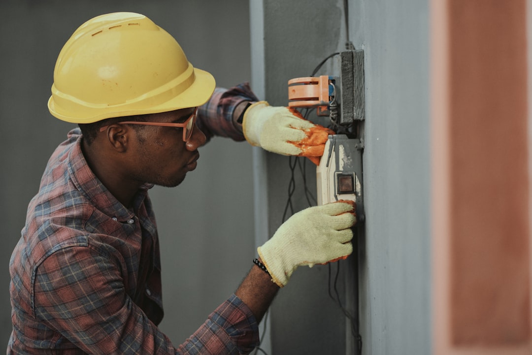 Friendly HVAC technician smiling at the front door of a coastal home, ready to help